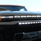 white hummer ev with amber drl roof light bar, white bumper light bar and ditch lights