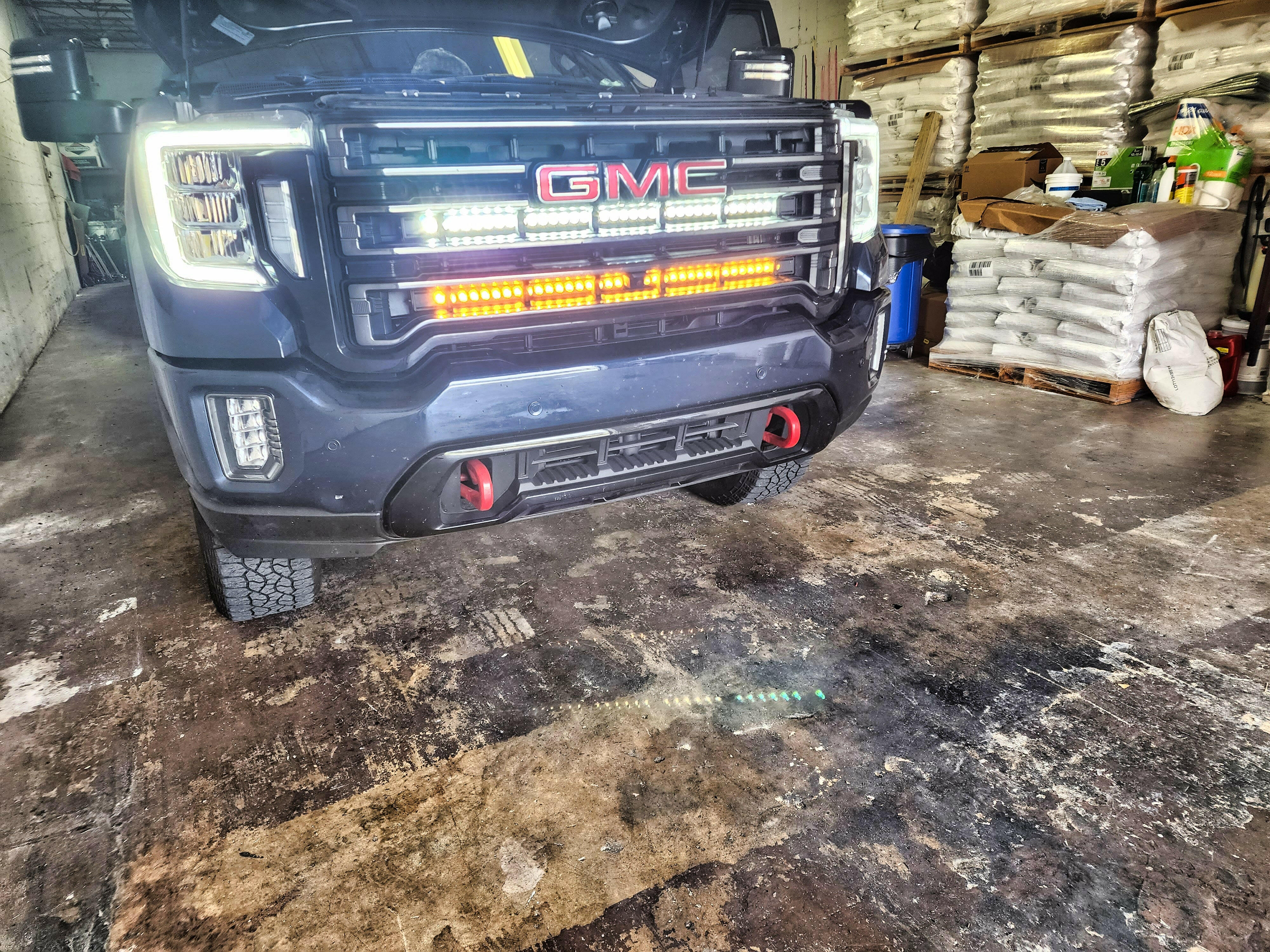 2020 2021 2022 2023 black GMC Sierra 2500 and 3500HD two 40in Light Bars behind the grille color amber and white 