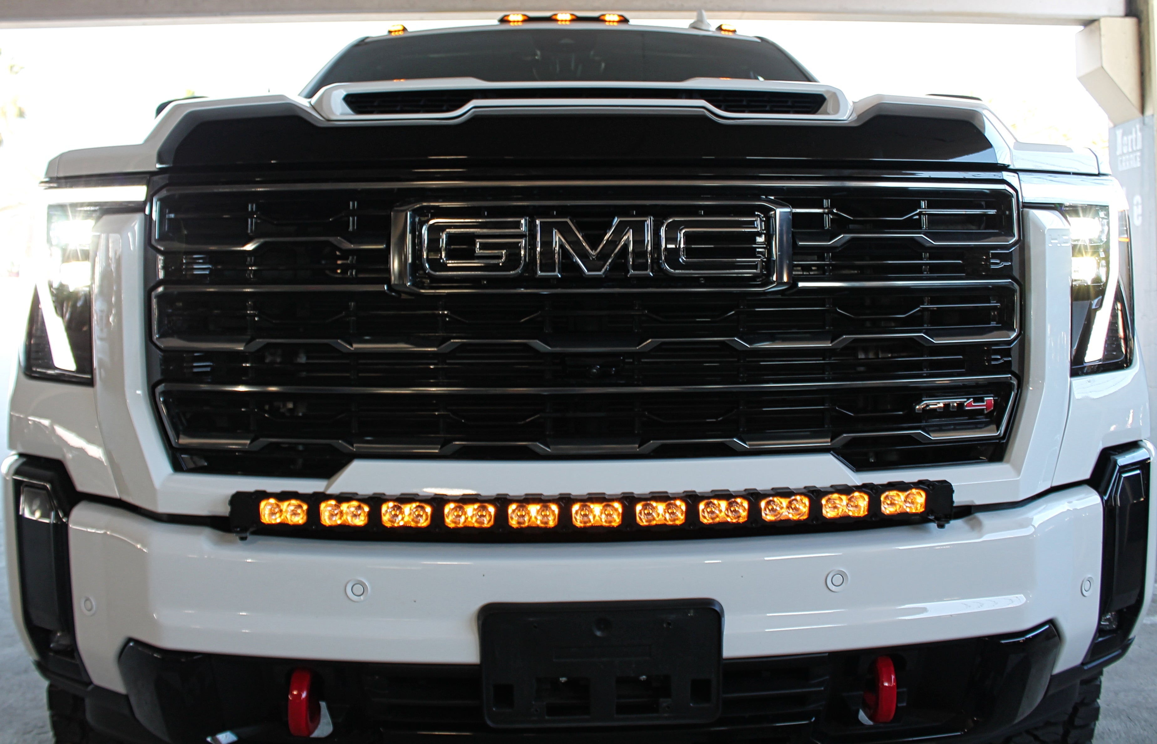 GMC Sierra HD light bar 40in PRO installed on 2024+ GMC Sierra 2500/3500 HD with AEV bumper, curved LED light bar slim to grille