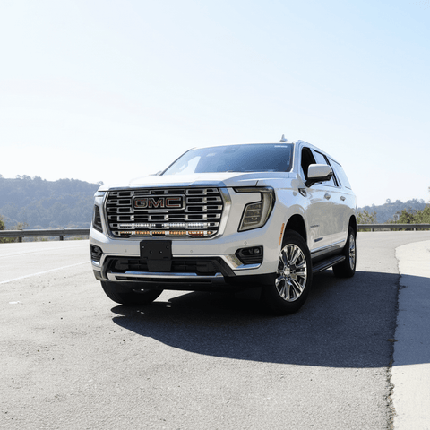 2025 2026 GMC Yukon with Dual 40s Slim Light Bars mounted under GMC grille on highway