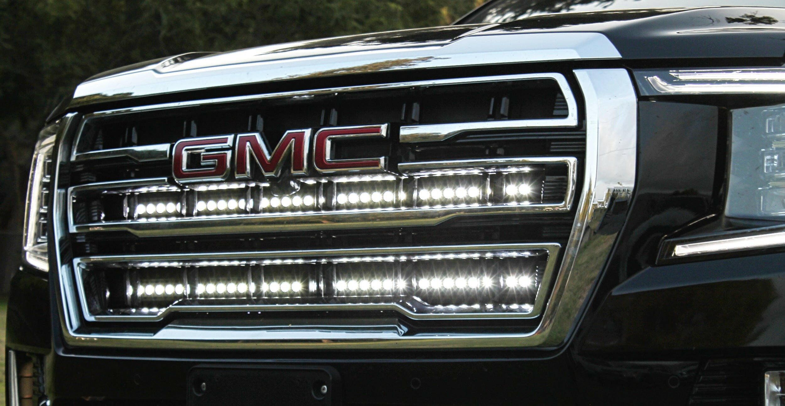 2021 2022 2023 2024 silver gmc yukon with two white 40in light bars behind the grille