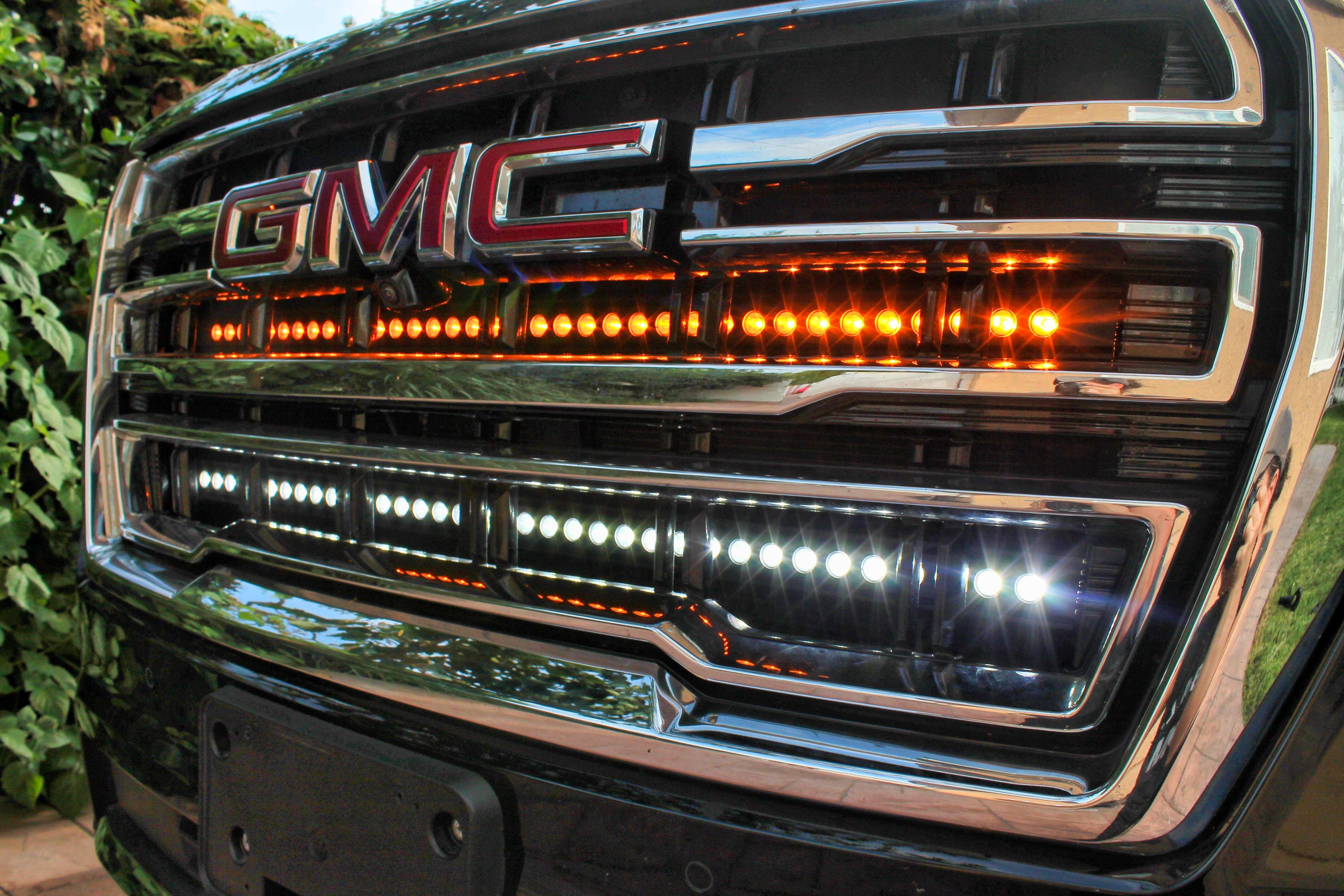 2021 2022 2023 2024 silver gmc yukon with two 40in light bars behind the grille color white and amber