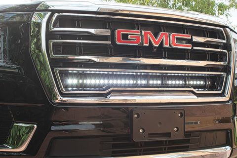 2023 2024 black gmc yukon with one 40in white light bar behind the grille
