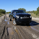 Silverado 1500 ditch lights installed on black Chevrolet Silverado 1500 driving off-road on muddy trail