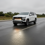 2025+ Chevrolet Suburban with dual 40s light bars on a wet road, showcasing Suburban Light Bars for enhanced visibility.
