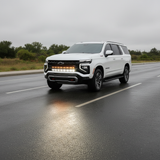 2025+ Chevrolet Suburban with dual 40s light bars on a wet road, showcasing Suburban Light Bars for enhanced visibility.