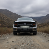2024+ Ford F150 with 30in Light Bar PRO on a dirt road in mountainous terrain, showcasing off-road capabilities.
