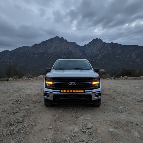 2024+ Ford F150 LightBar with illuminated lights in front of mountains in off-road setting.