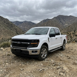 2024+ Ford F150 LightBar installed on a white Ford F150 in a mountain landscape.