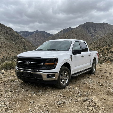 2024+ Ford F150 LightBar installed on a white Ford F150 in a mountain landscape.