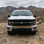 2024+ Ford F150 LightBar mounted on a white Ford F150 in an off-road setting with mountains in the background.