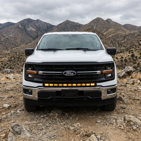 2024+ Ford F150 LightBar mounted on a white Ford F150 in an off-road setting with mountains in the background.
