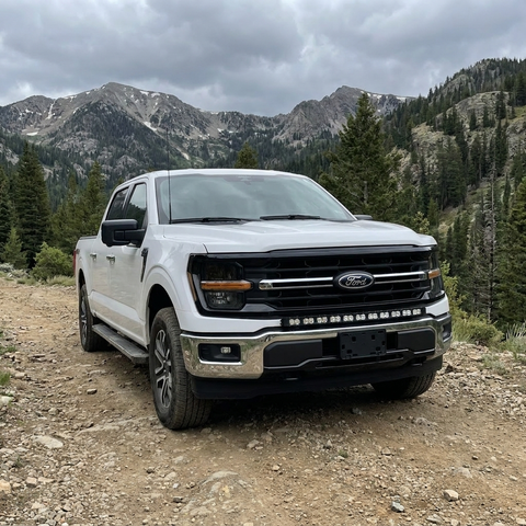 2024+ Ford F150 LightBar installed on a white truck in a mountainous off-road setting.