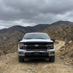 2024+ Ford F150 LightBar mounted on a Ford F150 in an off-road environment with mountains in the background.