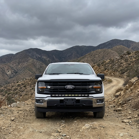2024+ Ford F150 LightBar mounted on a Ford F150 in an off-road environment with mountains in the background.
