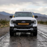Ford Ranger with the Ditch Lights PRO lit, front lighting on a rugged road