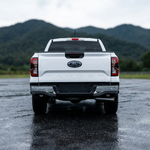 White Ford Ranger rear view with the reverse light kit and mountains in the background