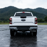 White Ford Ranger rear view with the reverse light kit and mountains in the background
