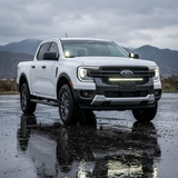 White Ford Ranger parked on wet, reflective ground showing the 30-inch SLIM LED grille light bar