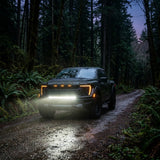2024 Ford F150 Raptor with light bar on forest trail, showcasing Ford F150 Raptor Light Bar in action.