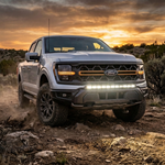 2024-2026 Ford F150 Tremor off-road LED light bar kit - silver truck on a rocky desert trail at sunset with 40 inch bumper-mount light bar lit, bolt-on no-drill install