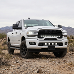 2025+ RAM 2500 40in PRO grille light bar lit in white on a white truck in the desert, front three-quarter view