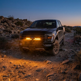 2021-2023 Ford F150 Tremor on a rocky trail at dusk with a single amber 30in LED light bar lit behind the grille
