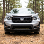 Close-up of the lower bumper on a 2021-2026 Honda Ridgeline with the 30in SLIM light bar amber DRL row lit
