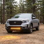 2021-2026 Honda Ridgeline front three-quarter with 30in SLIM light bar in amber lighting the dirt ahead of the truck