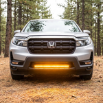 2021-2026 Honda Ridgeline straight-on front with 30in SLIM light bar lit amber, casting amber light on the ground