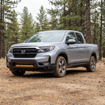 Driver-side front three-quarter of a 2021-2026 Honda Ridgeline with the 30in SLIM light bar lit amber low in the bumper