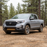 Driver-side front three-quarter of a 2021-2026 Honda Ridgeline with the 30in SLIM light bar lit amber low in the bumper