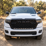 Head-on view of a white 2026 RAM 1500 HEMI with 40in light bar PRO mounted below the RAM grille