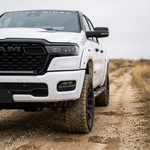 2026 RAM 1500 HEMI 40in SLIM light bar sits slim to the grille, front half view on a dirt road