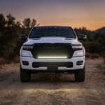 2026 RAM 1500 HEMI head-on with 40in SLIM light bar lighting the trail in white at dusk