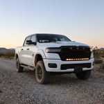 2026 RAM 1500 HEMI 40in light bar PRO with amber DRL backglow on a gravel trail at dusk