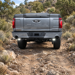 2022 Ford F-150 rear view on a rocky trail with LED reverse lights lit in white off-road light under the bumper