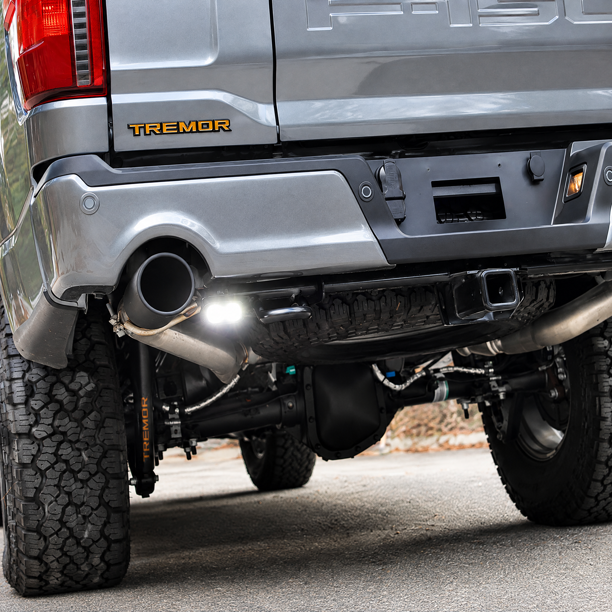 2026 Ford F-150 Tremor reverse light close-up, 20W PRO pod with white off-road light on under the rear bumper