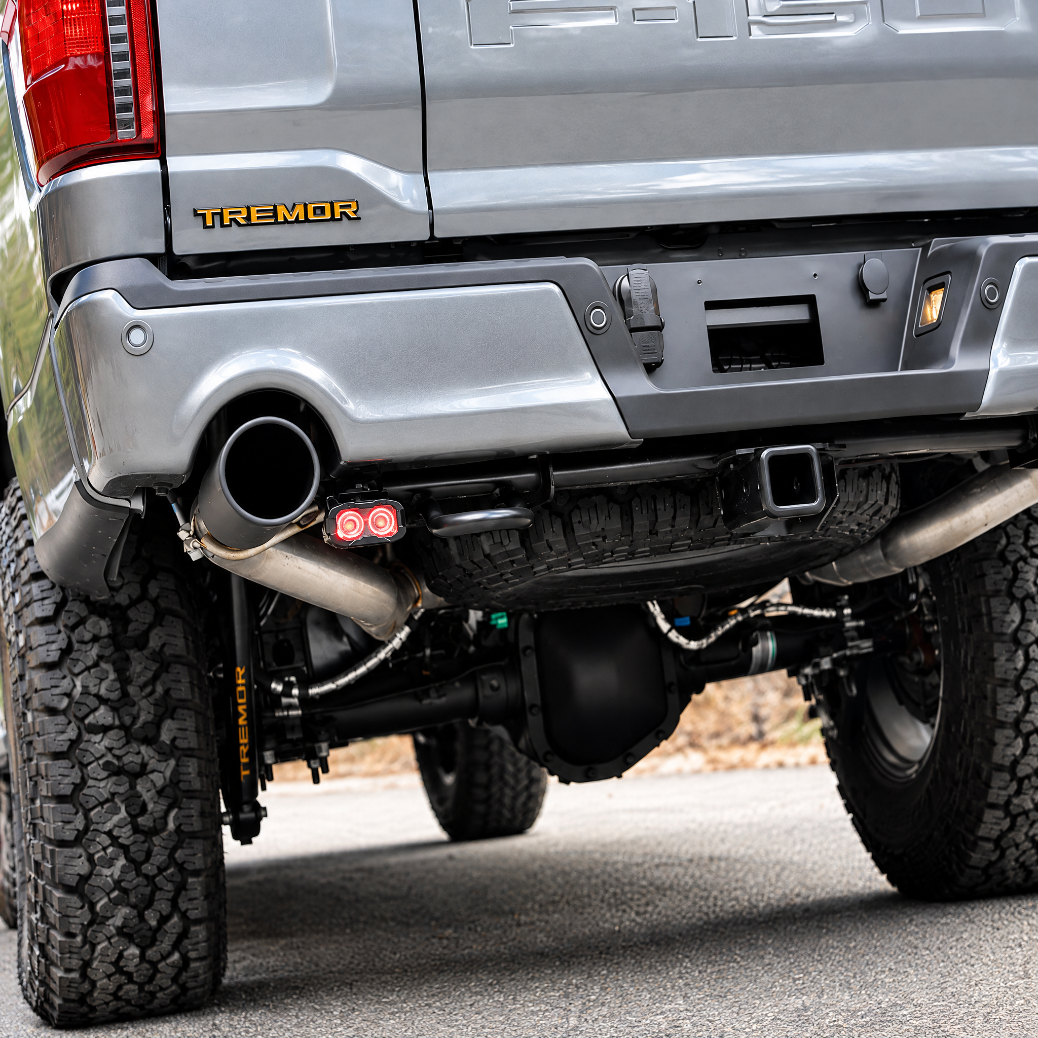 2025 Ford F-150 Tremor reverse light close-up, 20W PRO pod with red backlight mounted under the rear bumper