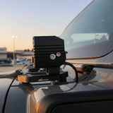 2025+ Jeep Gladiator ditch lights dual-color LED pod mounted on hood cowl bracket at sunset
