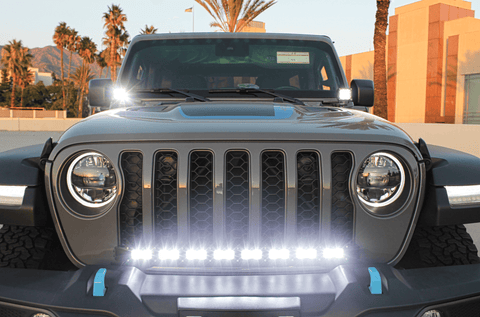 2019+ Jeep Gladiator ditch lights dual color LED hood mount pods and front light bar illuminated on gray Gladiator grille