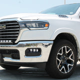 white 2025 ram 1500 with LED light bar on top bumper and fog lights