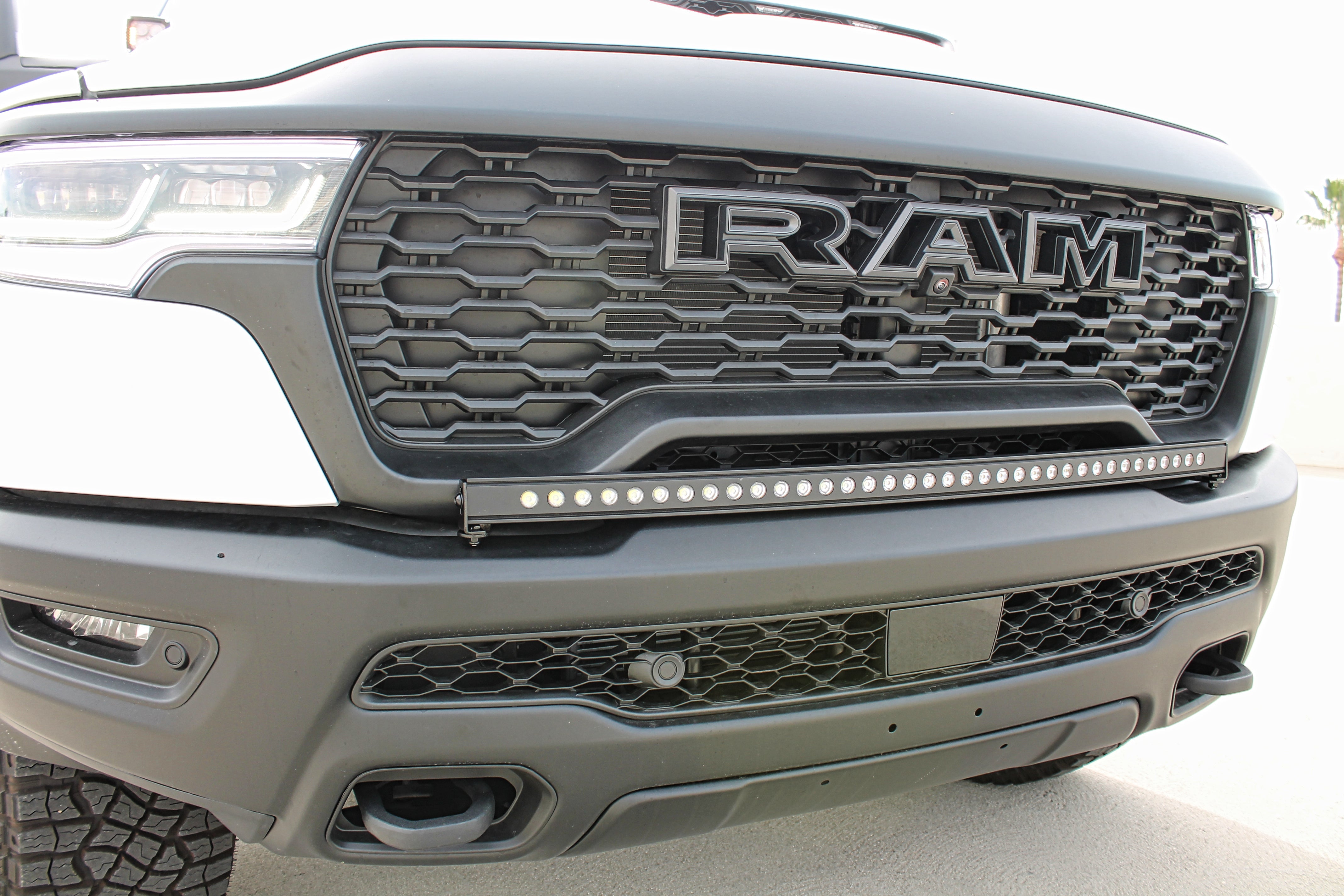 RAM RHO Lightbar installed on RAM 1500 RHO bumper, curved slim light bar with black powder-coated bracket for a built-in look