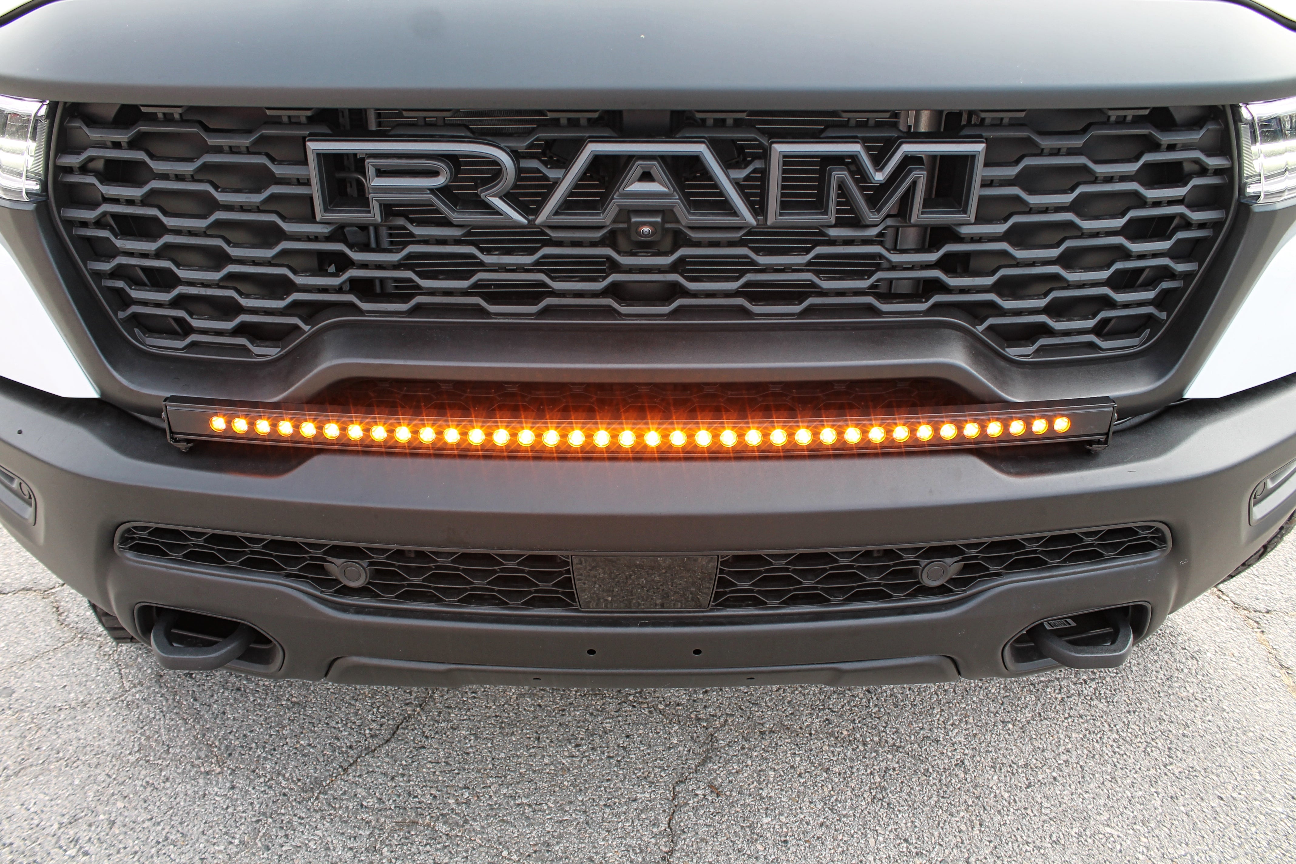 RAM RHO Lightbar 40in Slim on 2025+ RAM 1500 RHO - curved light bar follows bumper curvature, slim built-in look, black powder-coated bracket, no drilling