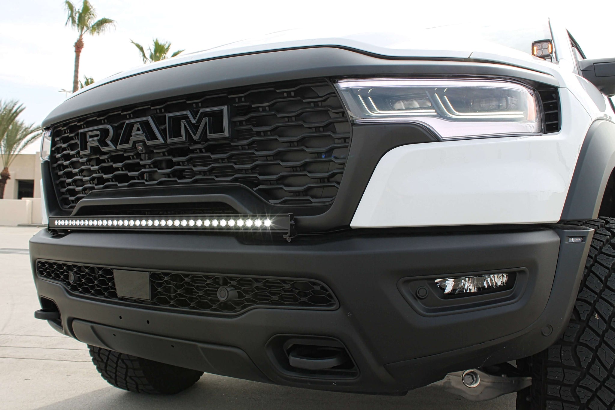 RAM RHO Lightbar 40in Slim on RAM 1500 RHO front bumper - curved light bar, black powder-coated bracket, no grille cutting, slim built-in look