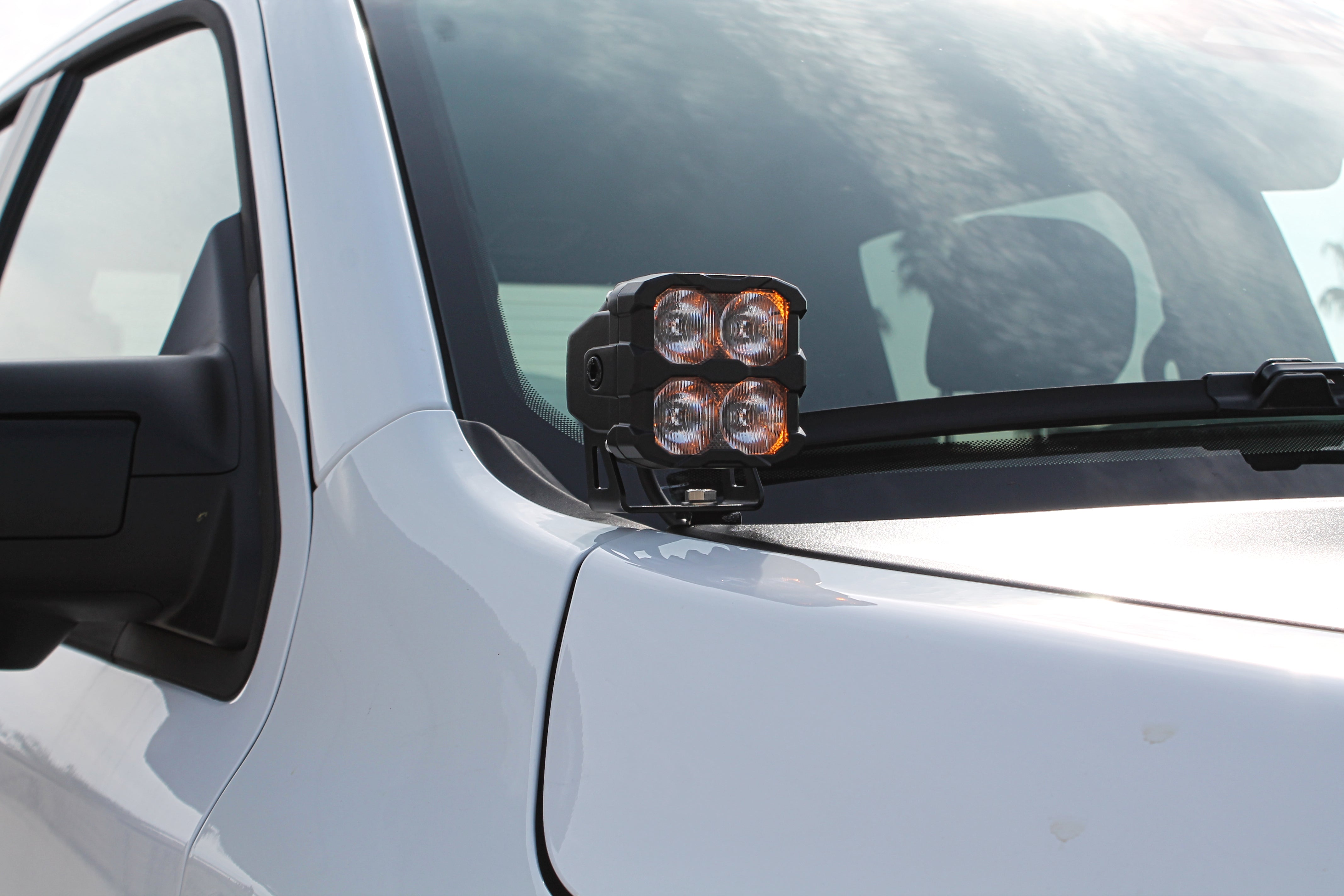 RAM RHO Ditch Lights - PRO 2025+ on white RAM 1500 with dual color amber DRL backglow