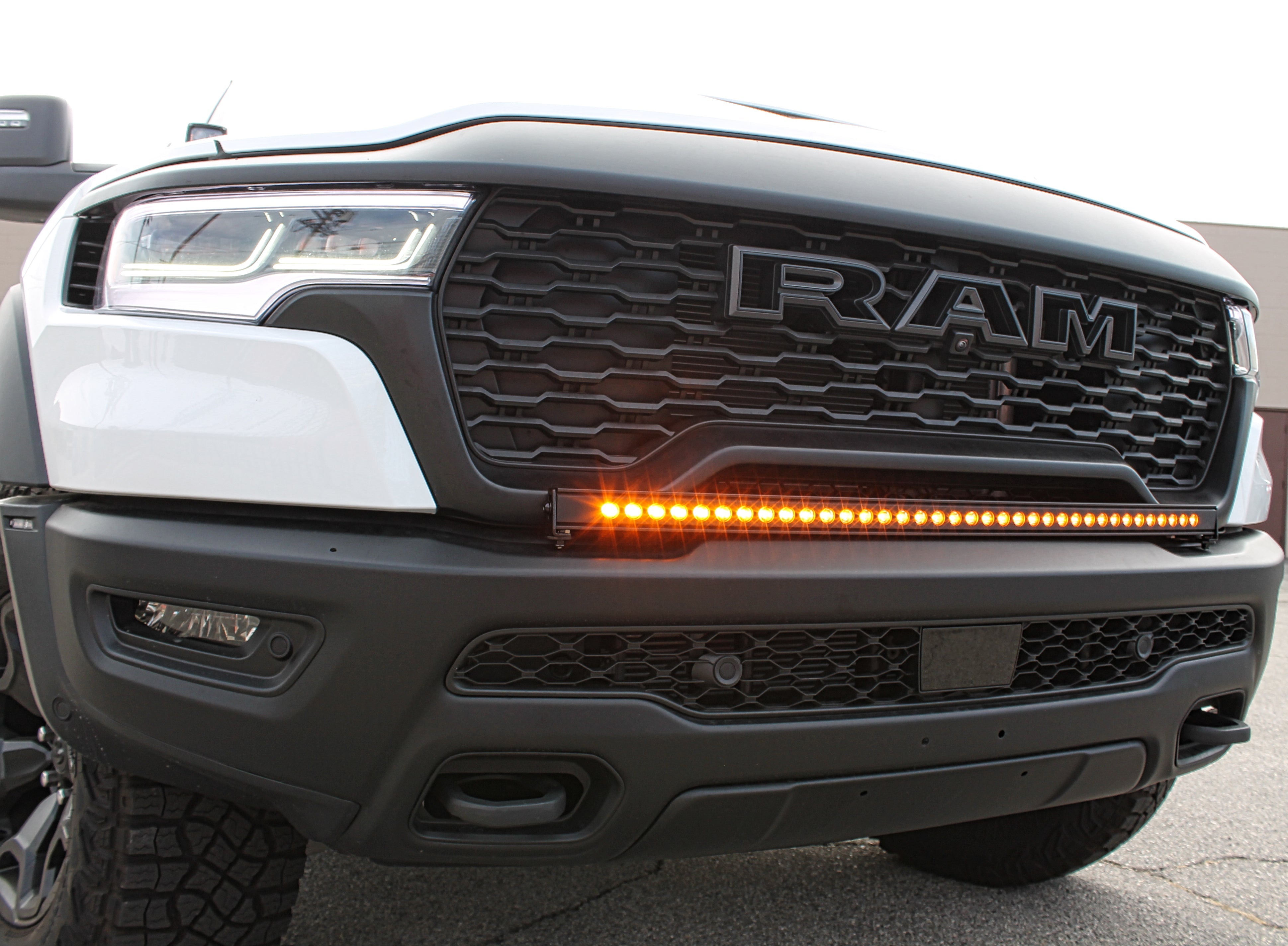 RAM RHO Lightbar on 2025+ RAM 1500 RHO — curved, slim LED light bar following bumper curvature with black powder-coated bracket
