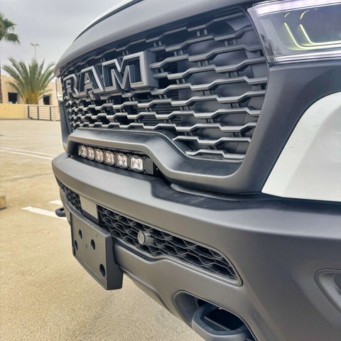 RAM RHO light bar PRO 23in curved LED installed between grille and bumper on 2025 RAM 1500 RHO