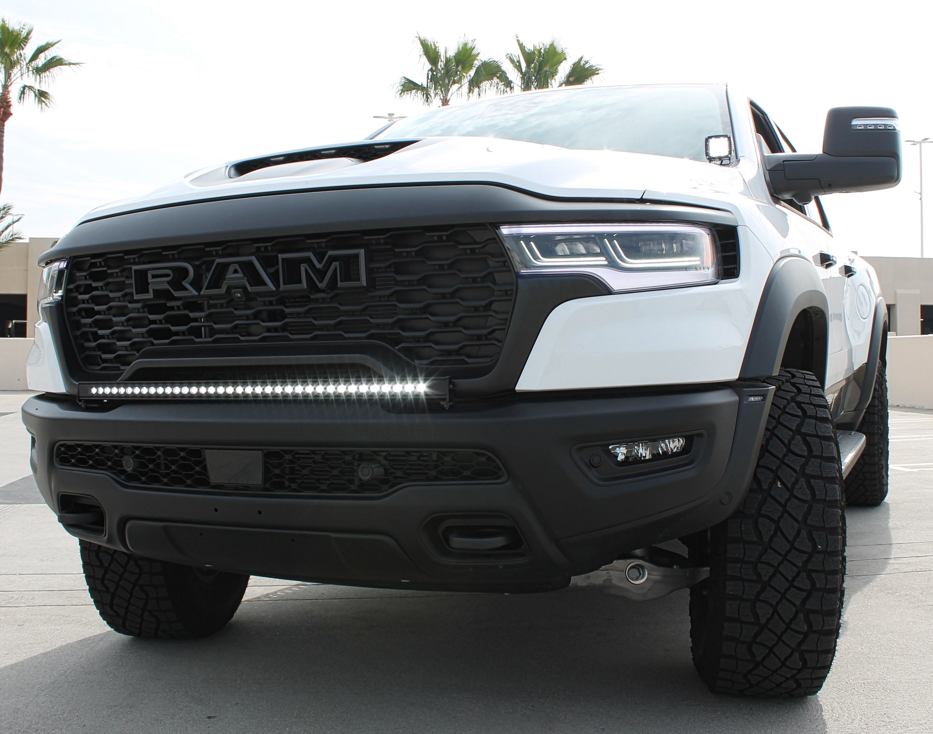 RAM RHO Lightbar on 2025+ RAM 1500 RHO — curved, slim front LED lightbar following bumper curvature, black powder-coated bracket, no drilling
