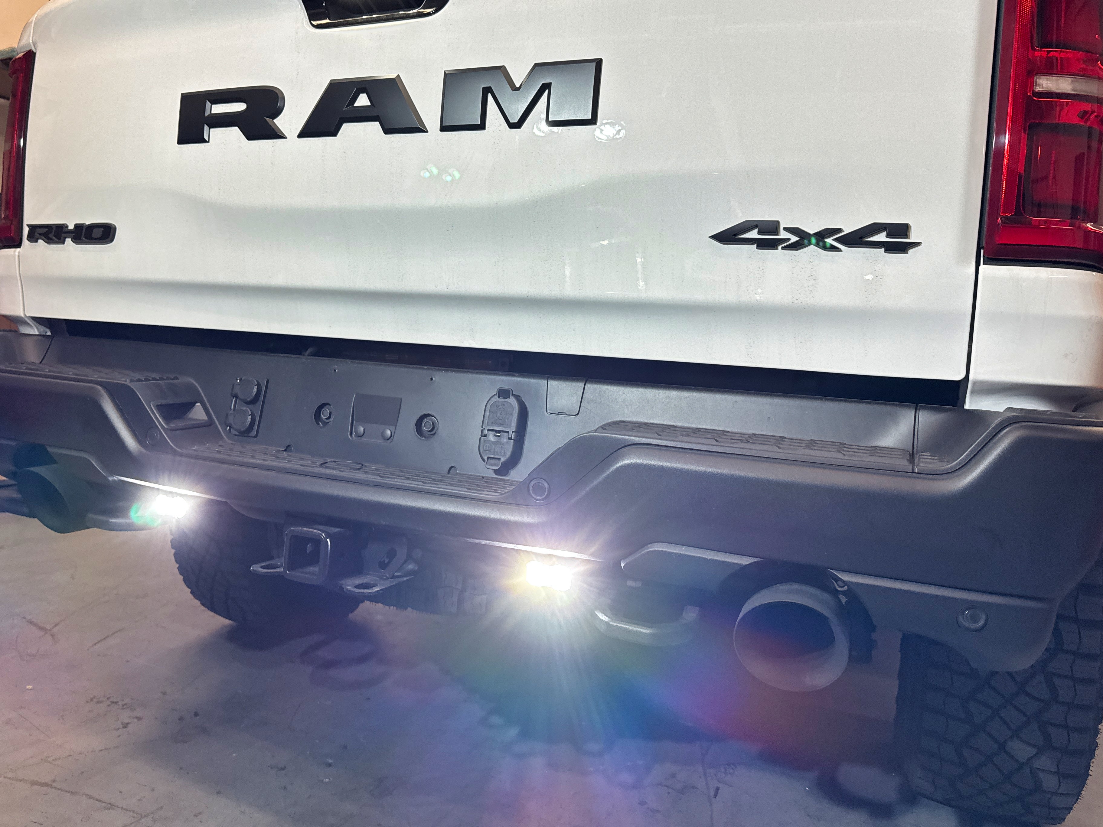RAM RHO REVERSE Reverse Light Kit logo on RAM pickup, back view with dual white LEDs and amber/red backlight options